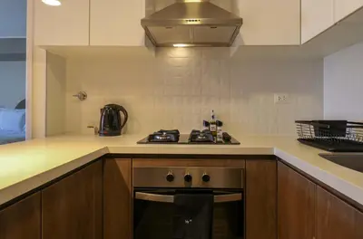 a kitchen with a stove top oven next to a sink at Marvelous 2BR with Balcony in Miraflores in Lima