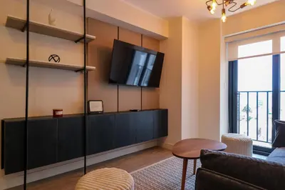 a living room with a tv on a wall at Marvelous 2BR with Balcony in Miraflores in Lima