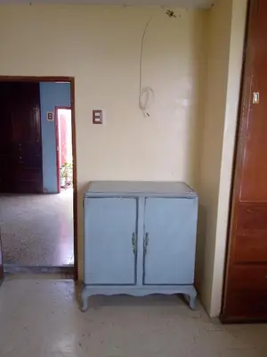 a white cabinet in a room with a doorway at San Juan in Lima
