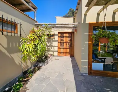 a entrance to a house with a wooden door at Spacious 4BR Country House with Pool in Mala in Asia