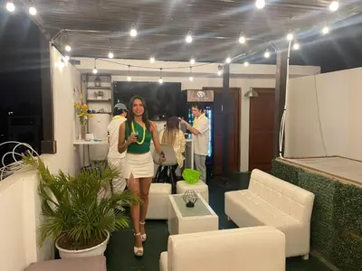 a woman walking through a room with people in it at Hostal Mirador in Pisco
