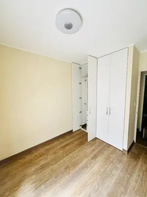 an empty room with white walls and wood floors at El Derby in Lima