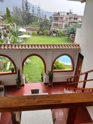 a balcony with a view of a yard at La Finca de la Norteñita 1926 in Santa Rosa de Quives