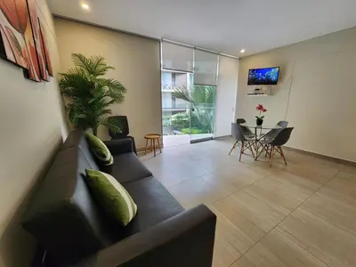 a living room with a couch and a table at Condominio Ocean Reef Playa Norte San Bartolo in San Bartolo