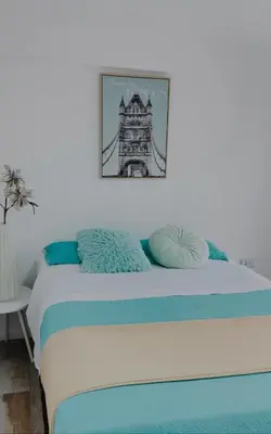 a bedroom with a bed with a picture of a bridge at Infinitive view San Bartolo in San Bartolo