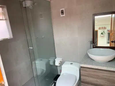 a bathroom with a shower and a toilet and a sink at Full Mini Apartment for 2 in Cusco