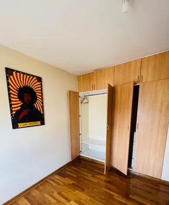 an empty room with a painting on the wall at Kira House in Lima