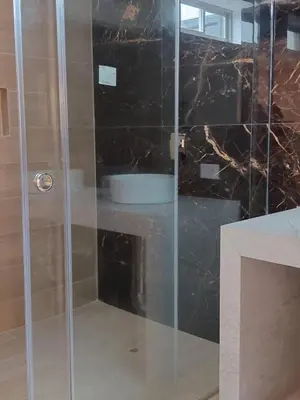 a shower with a glass door in a bathroom at Matrix Alojamiento in Punta Negra