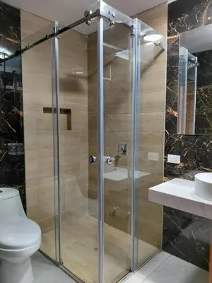 a bathroom with a shower with a toilet and a sink at Matrix Alojamiento in Punta Negra