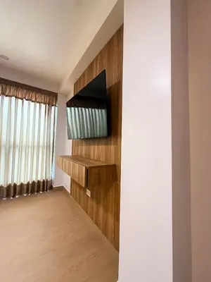 a living room with a television on a wall at Matrix Alojamiento in Punta Negra