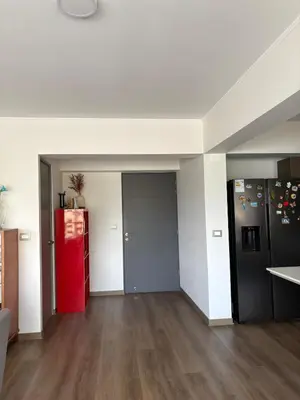 an empty living room with a red refrigerator at Beautiful brand new apartment for rent in Lima