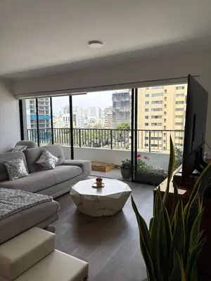 a living room with a couch and a coffee table at Beautiful brand new apartment for rent in Lima