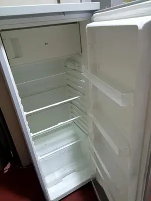 an empty refrigerator with its door open at Departamento 3 dormitorios 4A in Lima