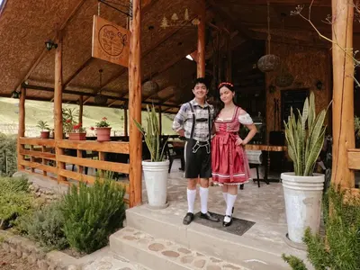 a man and a woman standing in front of a building at Lodge La Arboleda - Oxapampa in Oxapampa