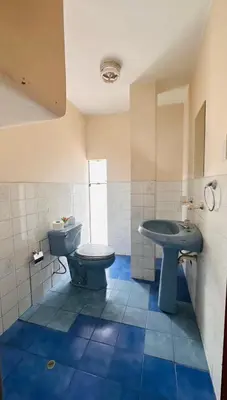a bathroom with a toilet and a sink at DEPARTAMENTO Chincha City 1 in Chincha
