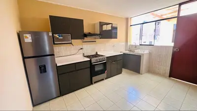 a kitchen with a refrigerator and a stove in it at DEPARTAMENTO Chincha City 1 in Chincha