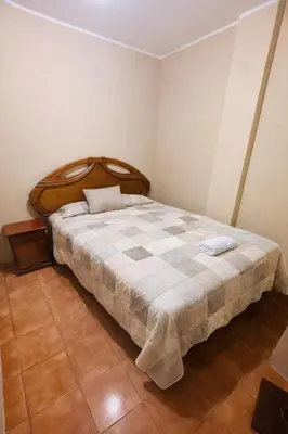 a bedroom with a large bed in a room at DEPARTAMENTO Chincha City 1 in Chincha