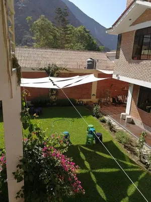 a view of a yard with a white umbrella at Departamento tranquilo en Condominio in Santa Eulalia