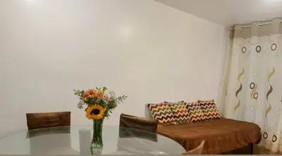 a living room with a glass table and a couch at Costa 21 Frente al Mar San Miguel in Lima