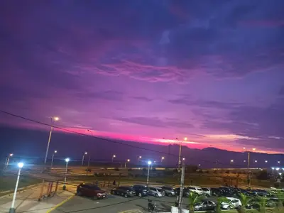 a parking lot at night with a purple sky at Costa 21 Frente al Mar San Miguel in Lima