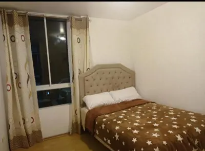 a small bedroom with a bed and a window at Costa 21 Frente al Mar San Miguel in Lima