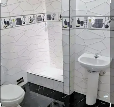 a white bathroom with a toilet and a sink at Costa 21 Frente al Mar San Miguel in Lima