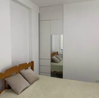 a bedroom with a bed and a mirror in it at Habitación privada con baño propio cerca de Paracas, Pisco in Pisco