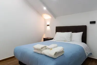 a bedroom with a bed with towels on it at Lama Vista Living 401 in Cusco