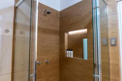a bathroom with a shower with a glass door at Lama Vista Living 401 in Cusco