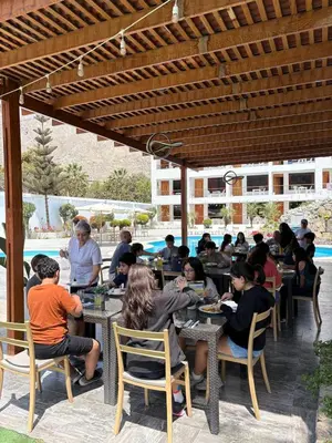 a group of people sitting at tables in a restaurant at Regina Hotel in Lunahuaná
