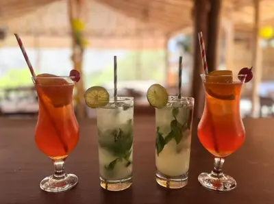 a group of four cocktails sitting on a table at Regina Hotel in Lunahuaná