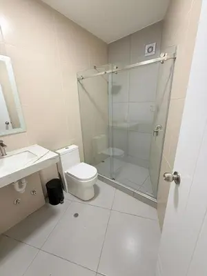 a bathroom with a shower and a toilet and a sink at Duplex Condominio Míkonos Asia in Asia