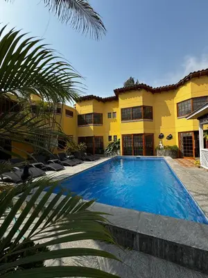 a swimming pool in front of a building at Hostal Sol Y Luna - Cieneguilla in Cieneguilla