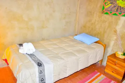 a small bed with two stuffed animals on top of it at Albergue Salkantay Chawllay in Santa Teresa