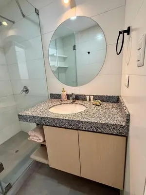 a bathroom with a sink and a mirror at Departamento San Martin in Lima