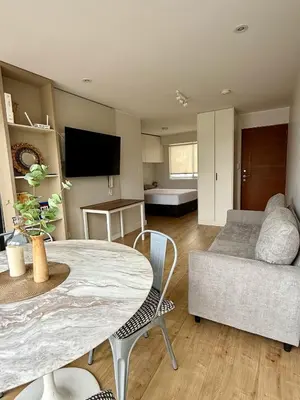 a living room with a table and a couch at Departamento San Martin in Lima