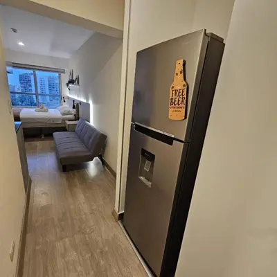 a kitchen with a refrigerator with a sign on it at PERU STAY Barranco in Lima
