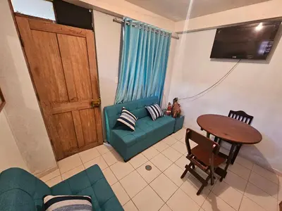 a living room with a green couch and a table at Pantaq hostal in Cusco