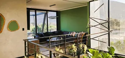 a living room with a couch and a green wall at Private 4BR Getaway with Pool & Cinema in Ica