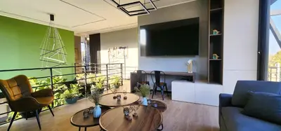 a living room with two tables and a flat screen tv at Private 4BR Getaway with Pool & Cinema in Ica