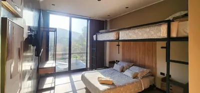 a bedroom with two bunk beds and a balcony at Private 4BR Getaway with Pool & Cinema in Ica