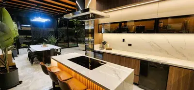 a kitchen with a counter and a table with chairs at Private 4BR Getaway with Pool & Cinema in Ica
