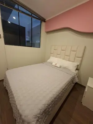 a bedroom with a bed with a large window at Beach House - Besso Beach in Barranca
