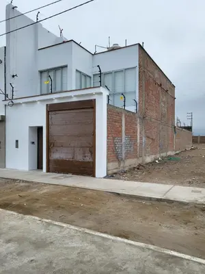 an empty parking lot with a large garage at Chilca, ATM Beach House in Salinas