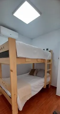 a couple of bunk beds in a room at Chilca, ATM Beach House in Salinas