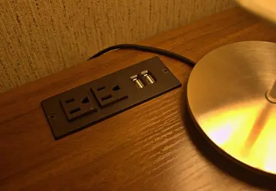 a lightswitch sitting on top of a wooden table at Cesar's Apartment - Los Laureles in Lima