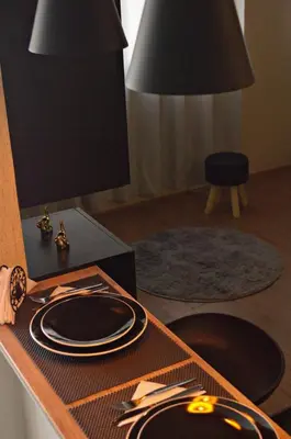 a table with plates and utensils on top of it at Cesar's Apartment - Los Laureles in Lima