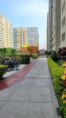 an empty sidewalk in a city with buildings at Cesar's Apartment - Los Laureles in Lima