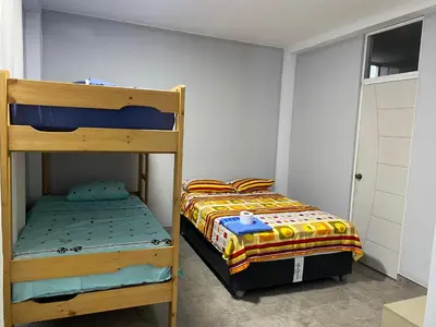 a bedroom with two bunk beds and a window at Ruta del Oasis - Huacachina in Ica