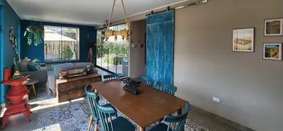 a dining room with a wooden table and chairs at Quiet 2BR Villa whit Pool & Games in Ica